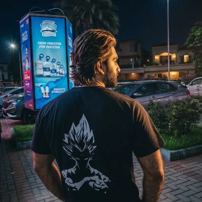 Adeel Habib standing in a Rawalpindi car park at night, seen from behind